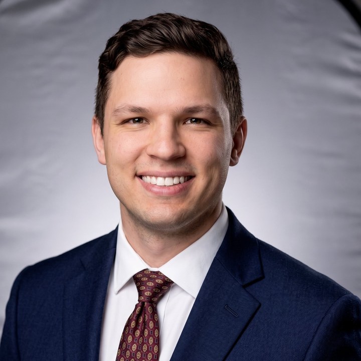 Adam Crocker, smiling, in a navy suit